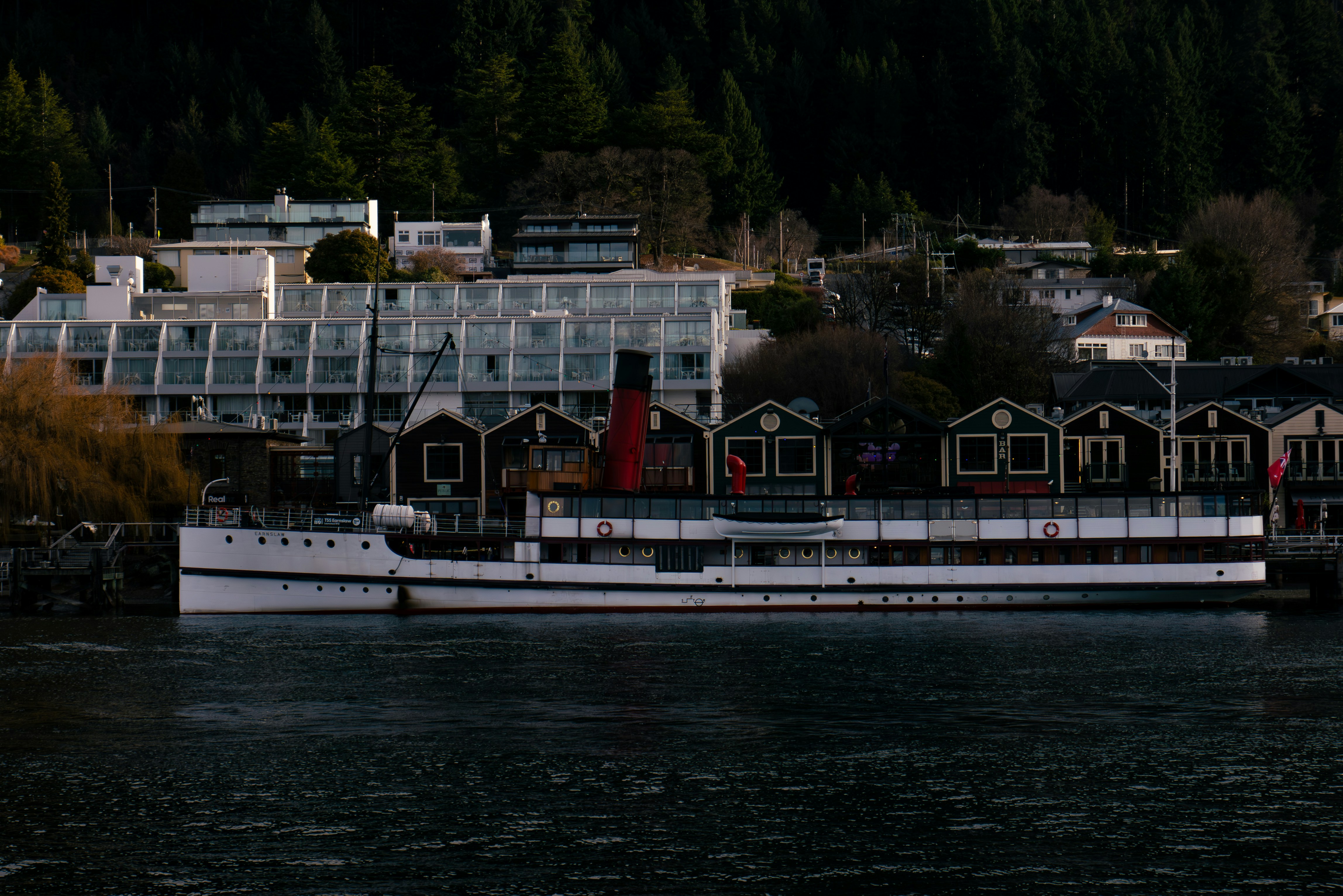A large white boat floating on top of a lake