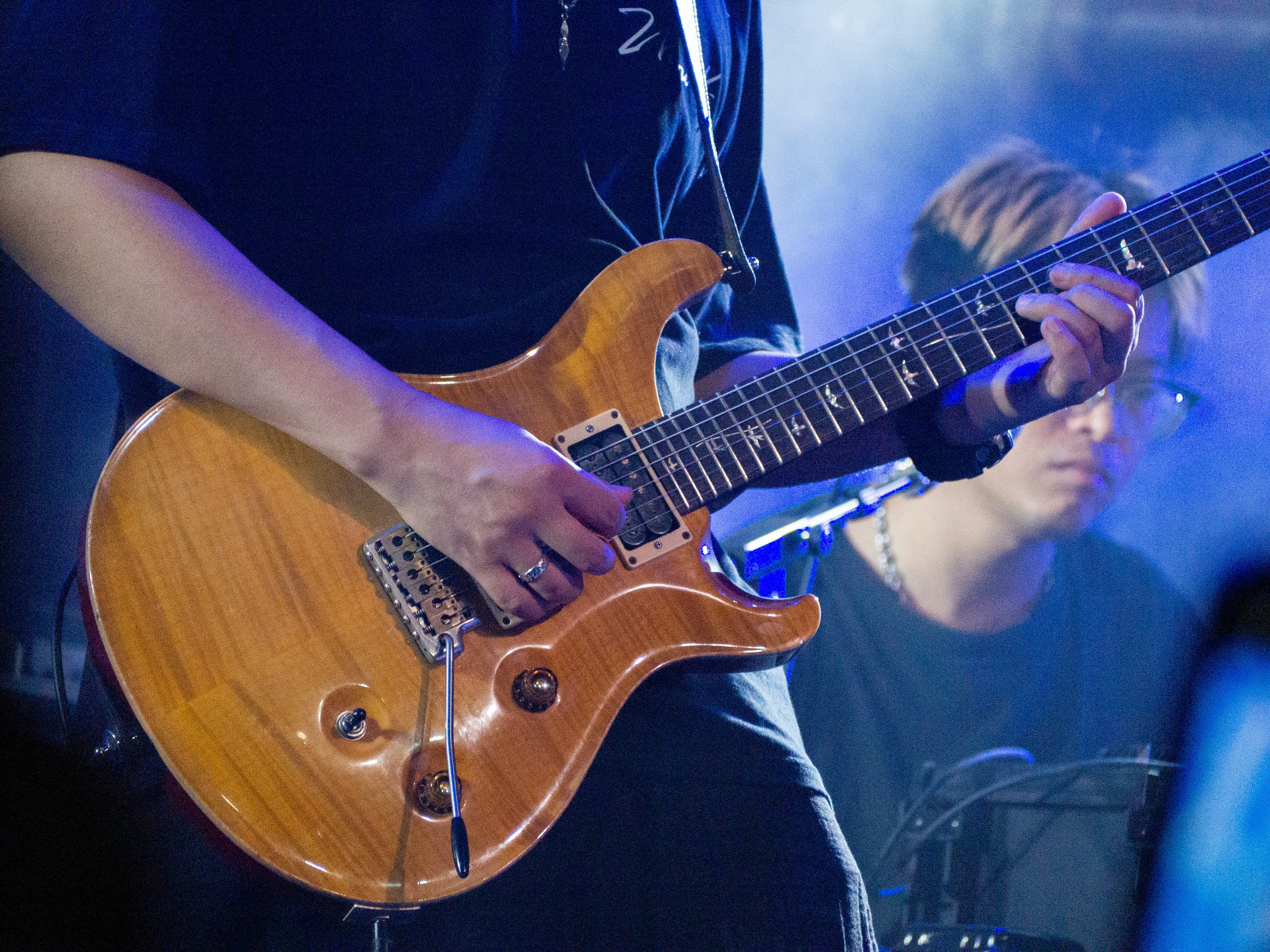 A man playing a guitar on a stage