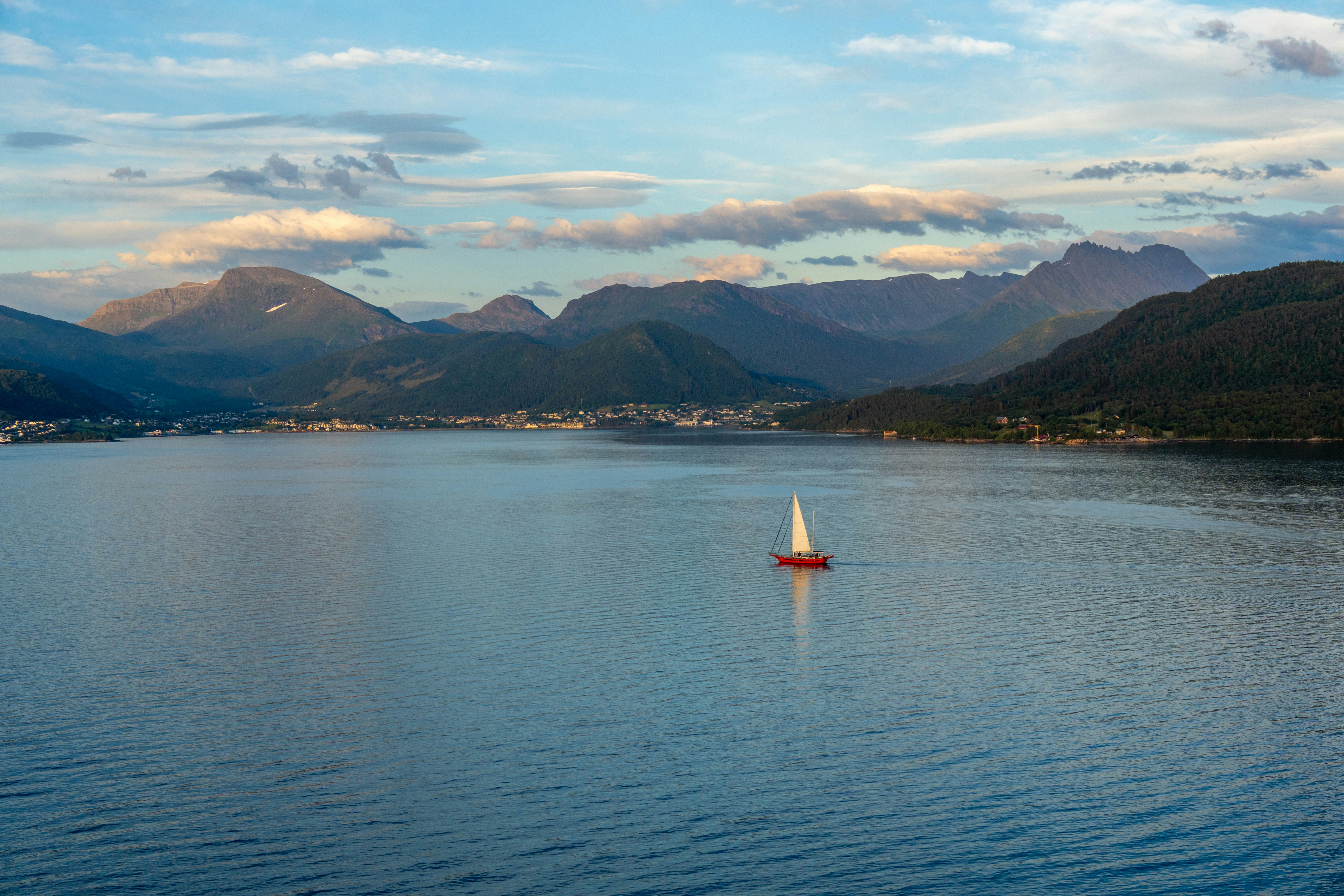 A small sailboat in a large body of water
