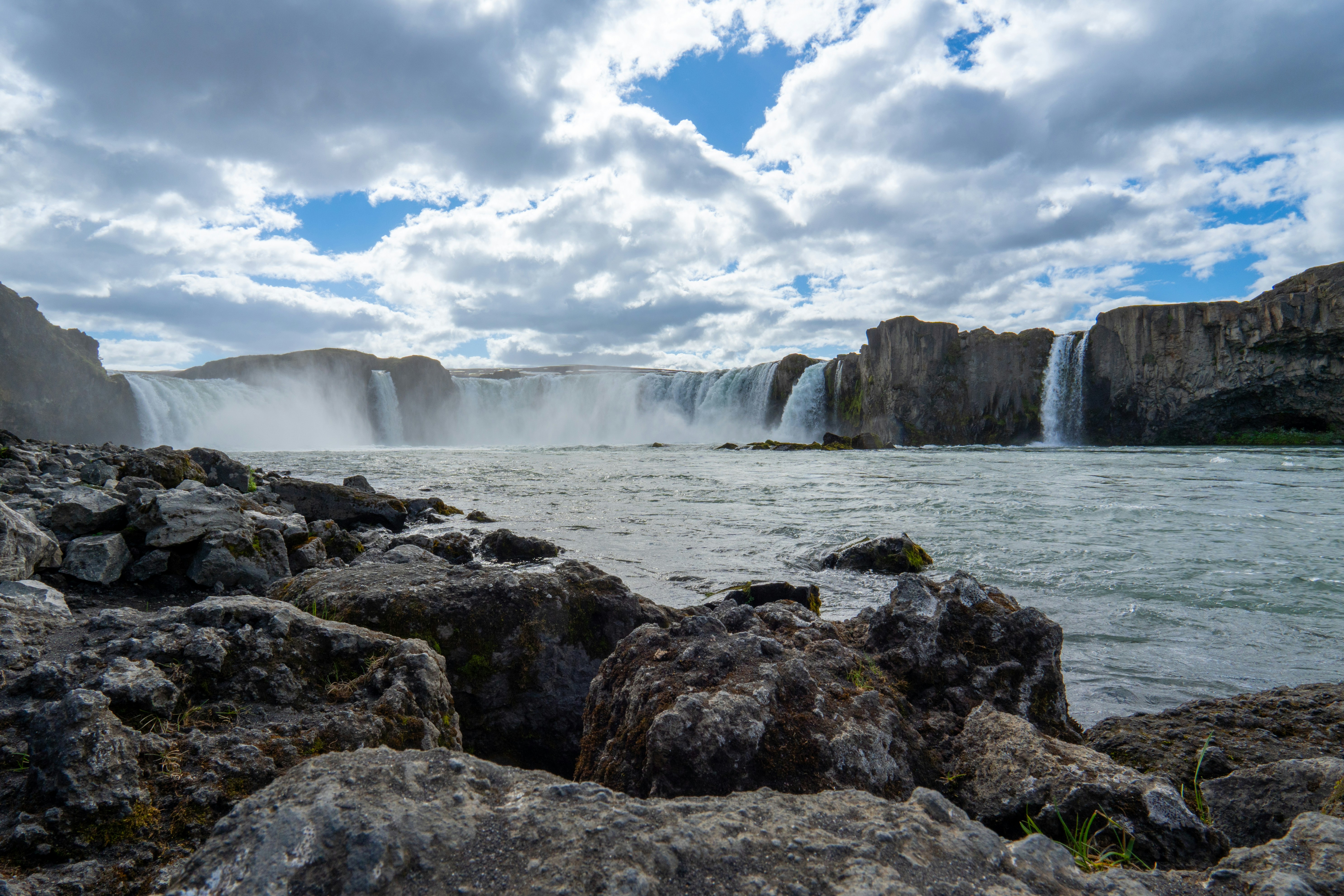 A view of a waterfall from a rocky shore