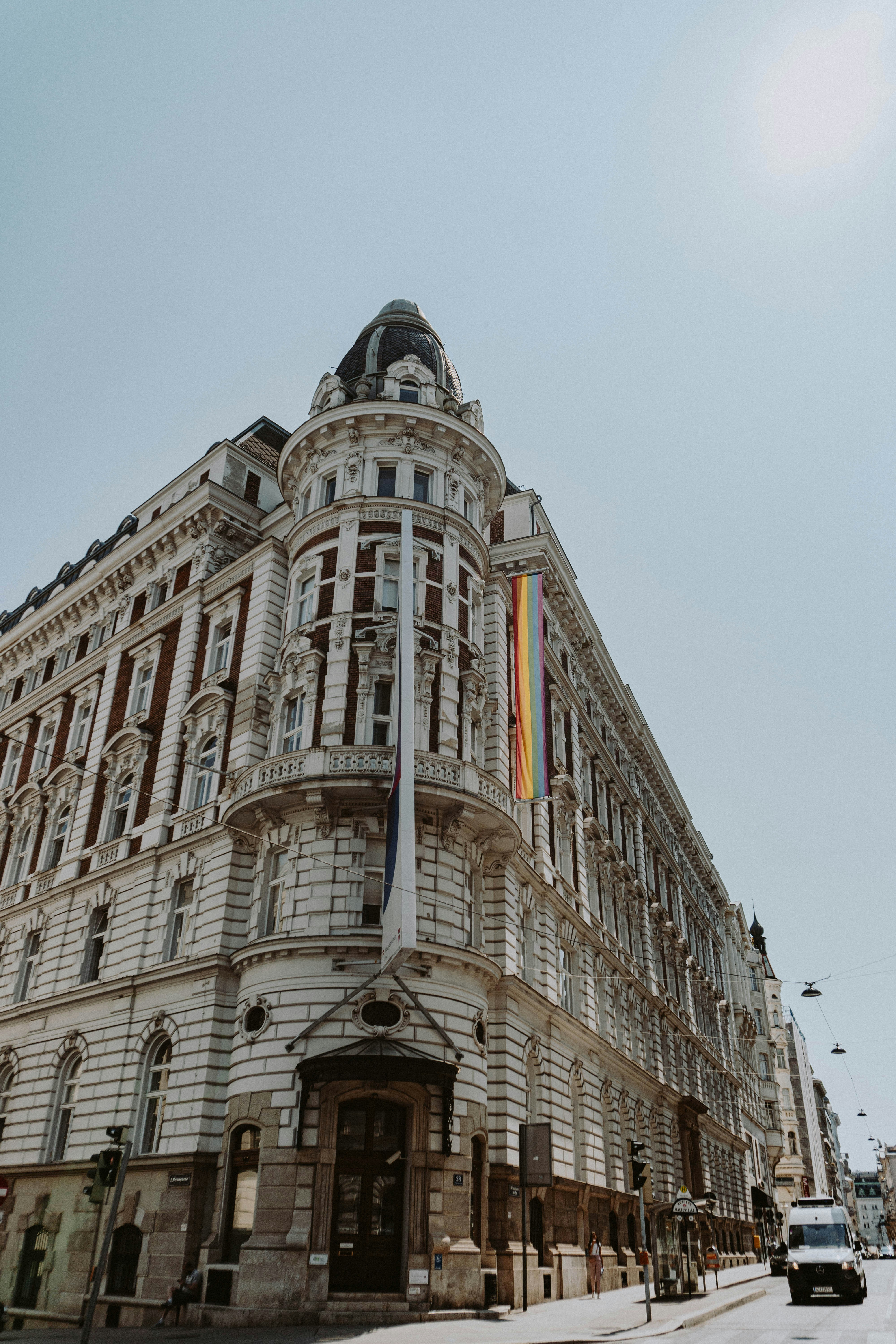 A very tall building with a rainbow flag on it's side