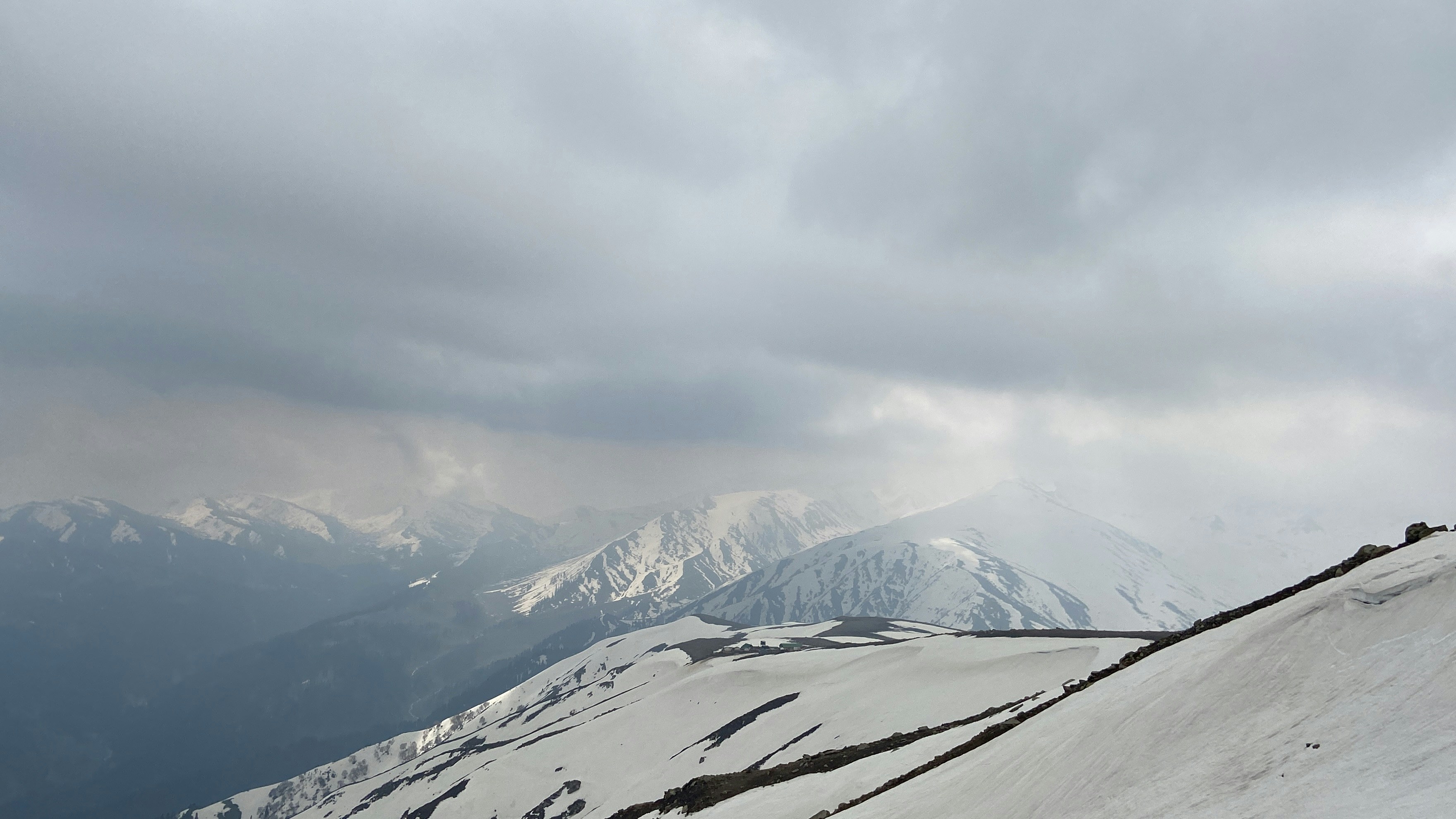 Gulmarg gondola cable car above snow-covered Himalayan slopes — Kashmir winter tour Safari Sutra