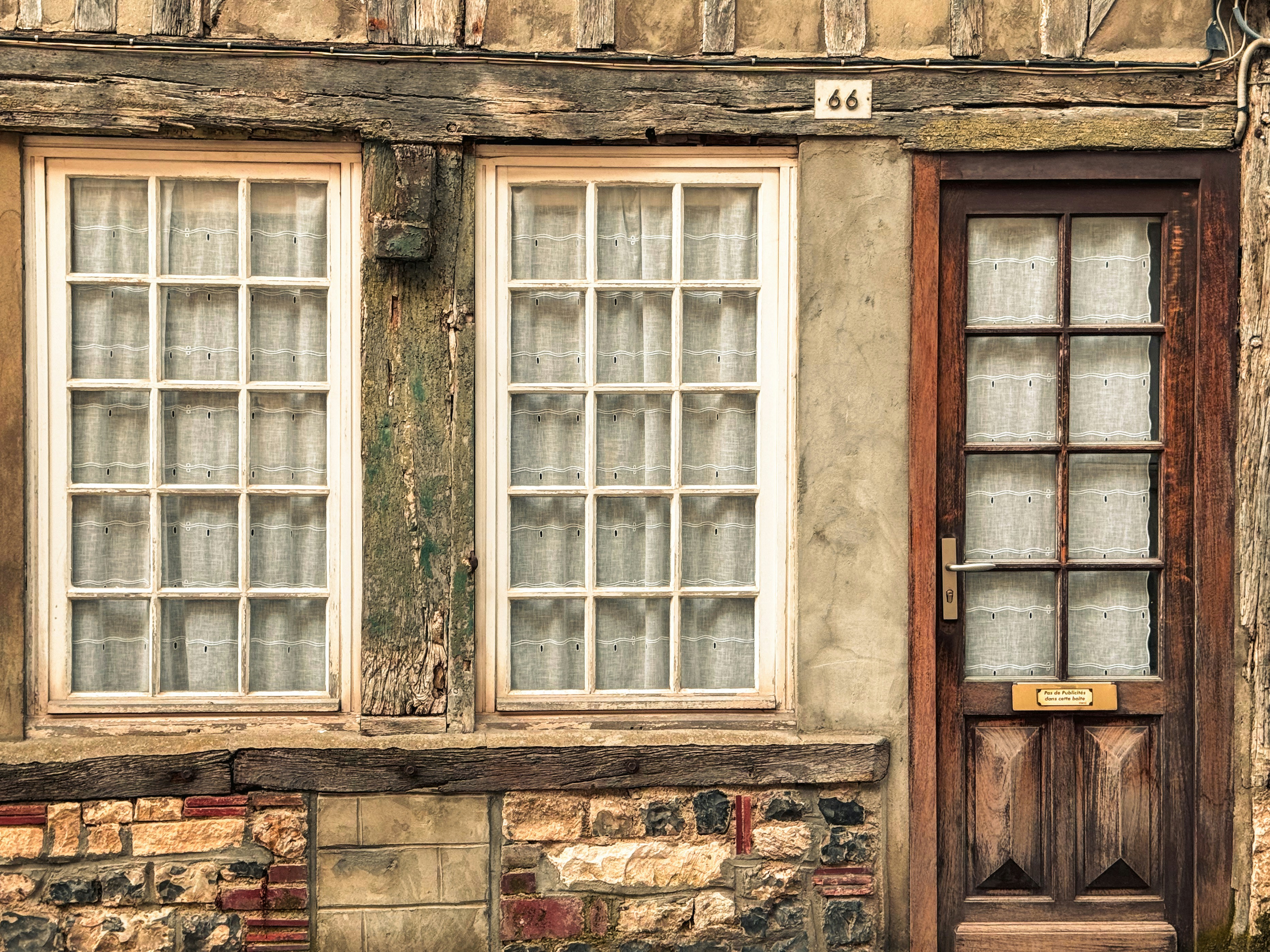 An old building with two windows and a door