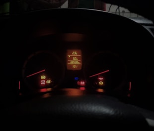 The dashboard of a car at night time