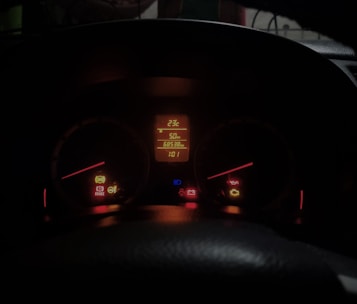 The dashboard of a car at night time