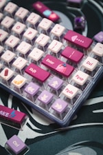 A close up of a pink and purple keyboard