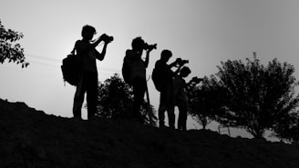 A group of people standing on top of a hill