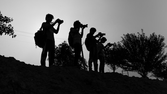 A group of people standing on top of a hill