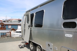 A silver trailer parked on top of a roof