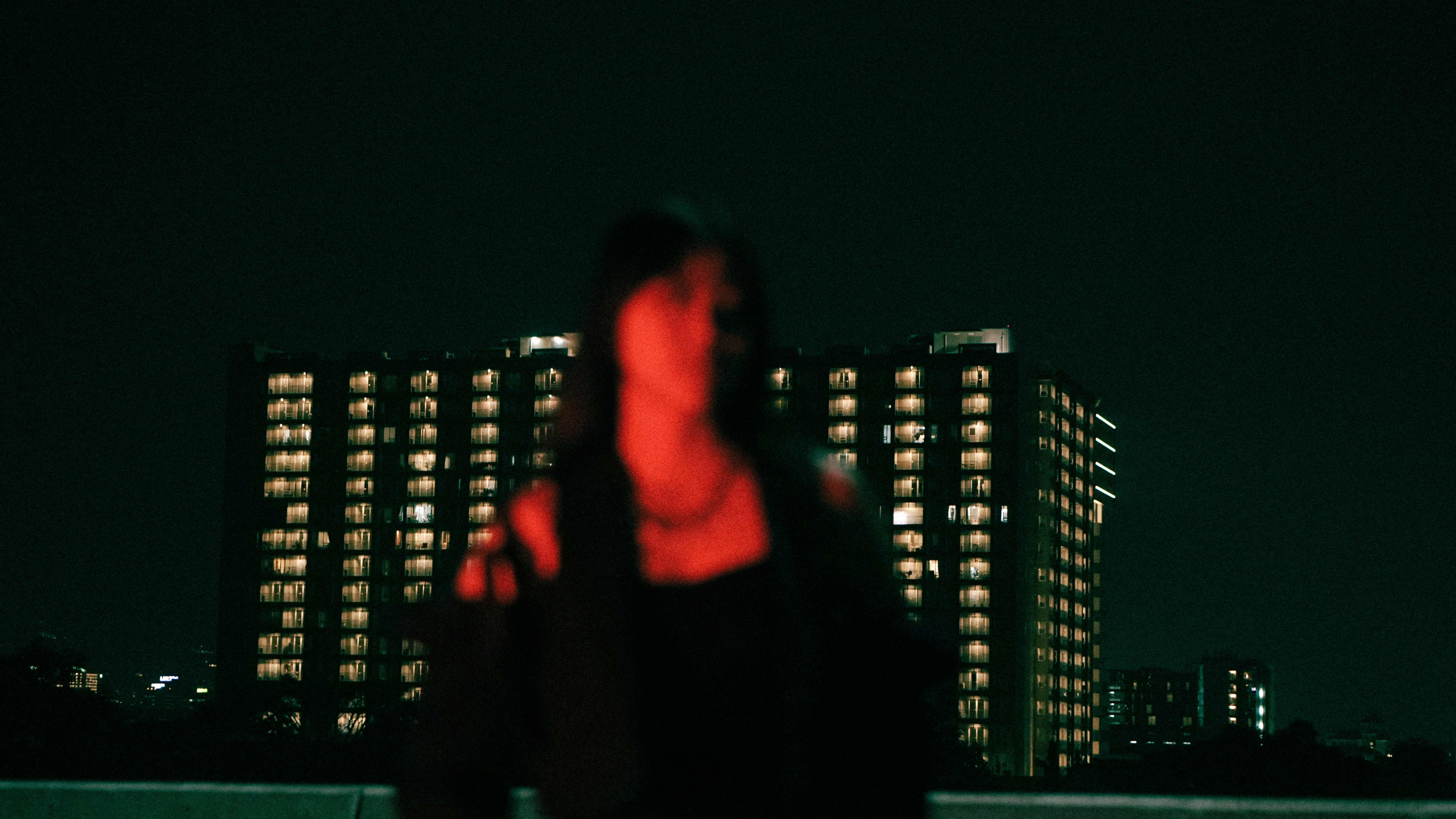 A blurry photo of a woman standing in front of a building
