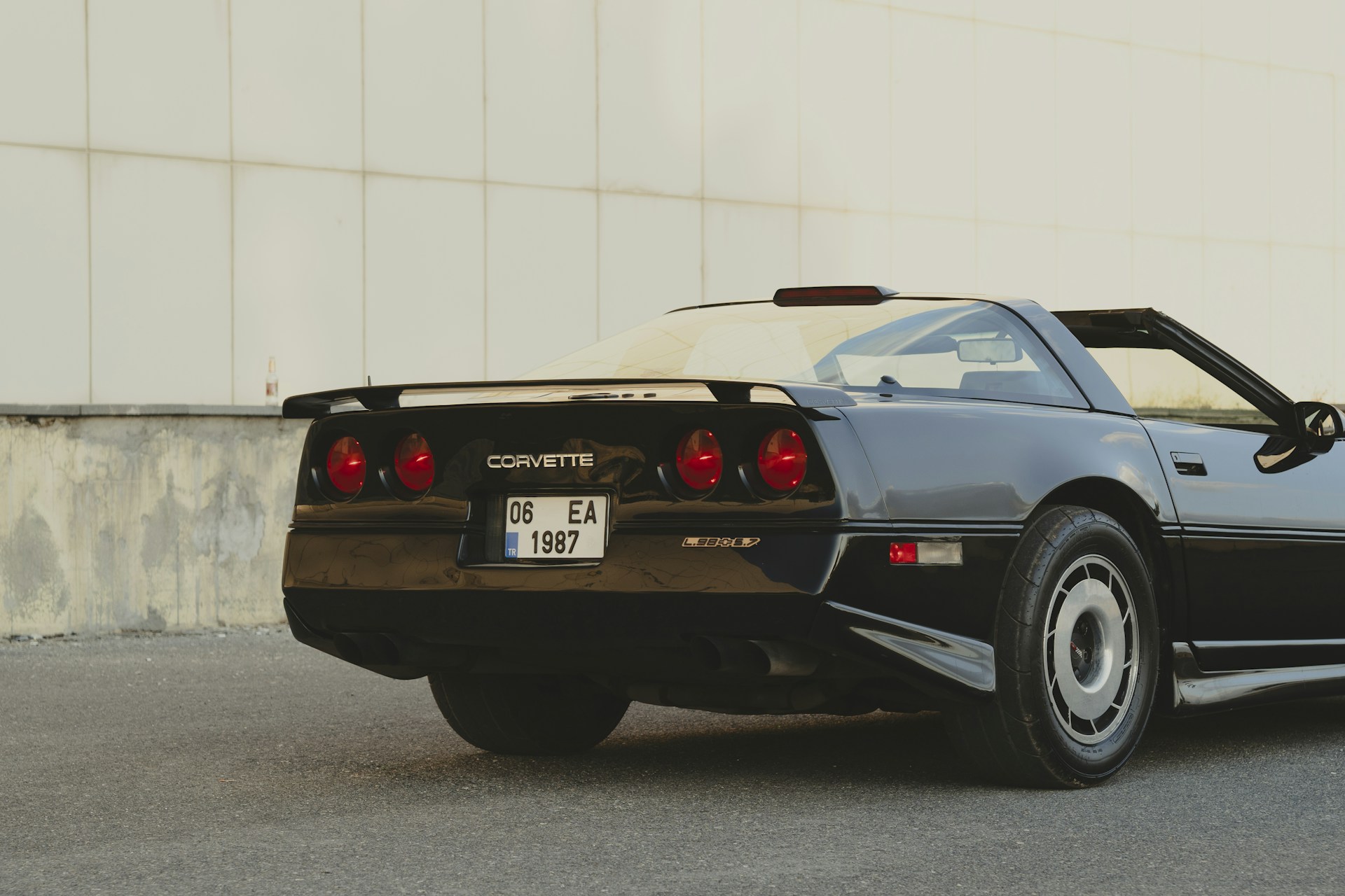 A black sports car parked in front of a building