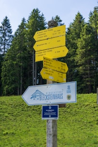 A wooden pole with a bunch of signs on top of it