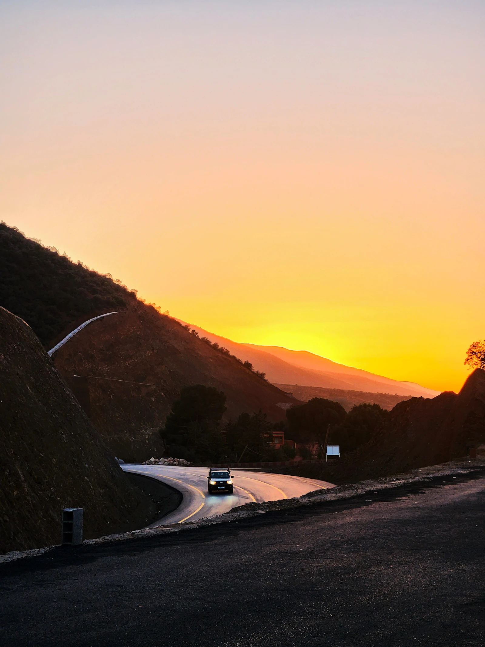 A car on a mountain road at sunset in Morocco