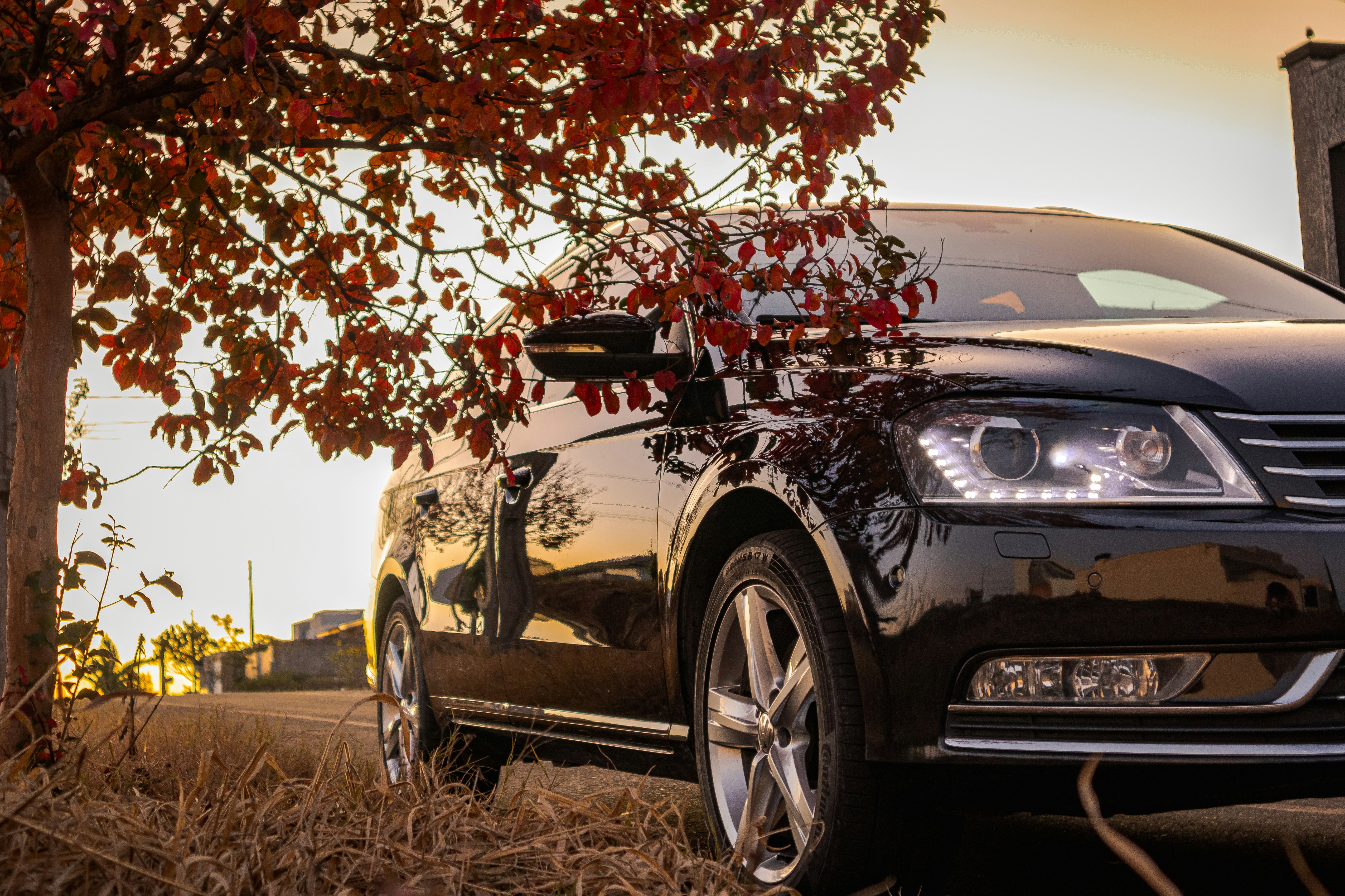 A black car parked in front of a house