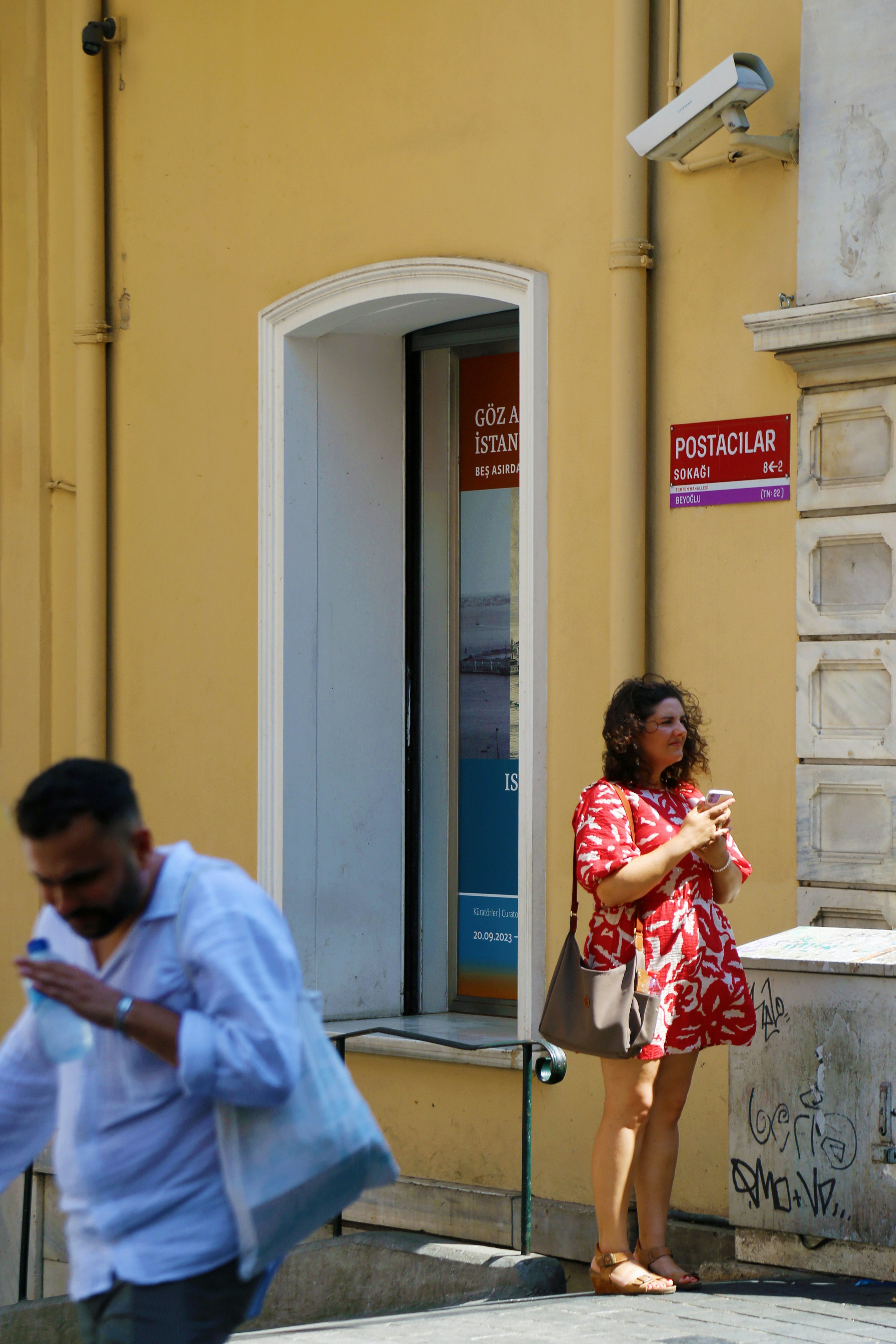 A man and a woman walking down a street