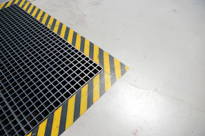 A metal grate sitting on top of a white floor