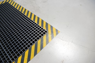 A metal grate sitting on top of a white floor