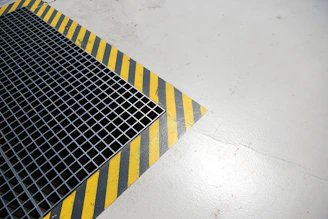 A metal grate sitting on top of a white floor