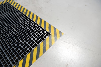 A metal grate sitting on top of a white floor