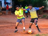 A couple of young men playing a game of soccer