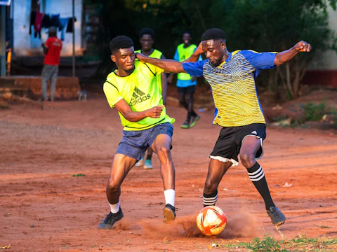A couple of young men playing a game of soccer