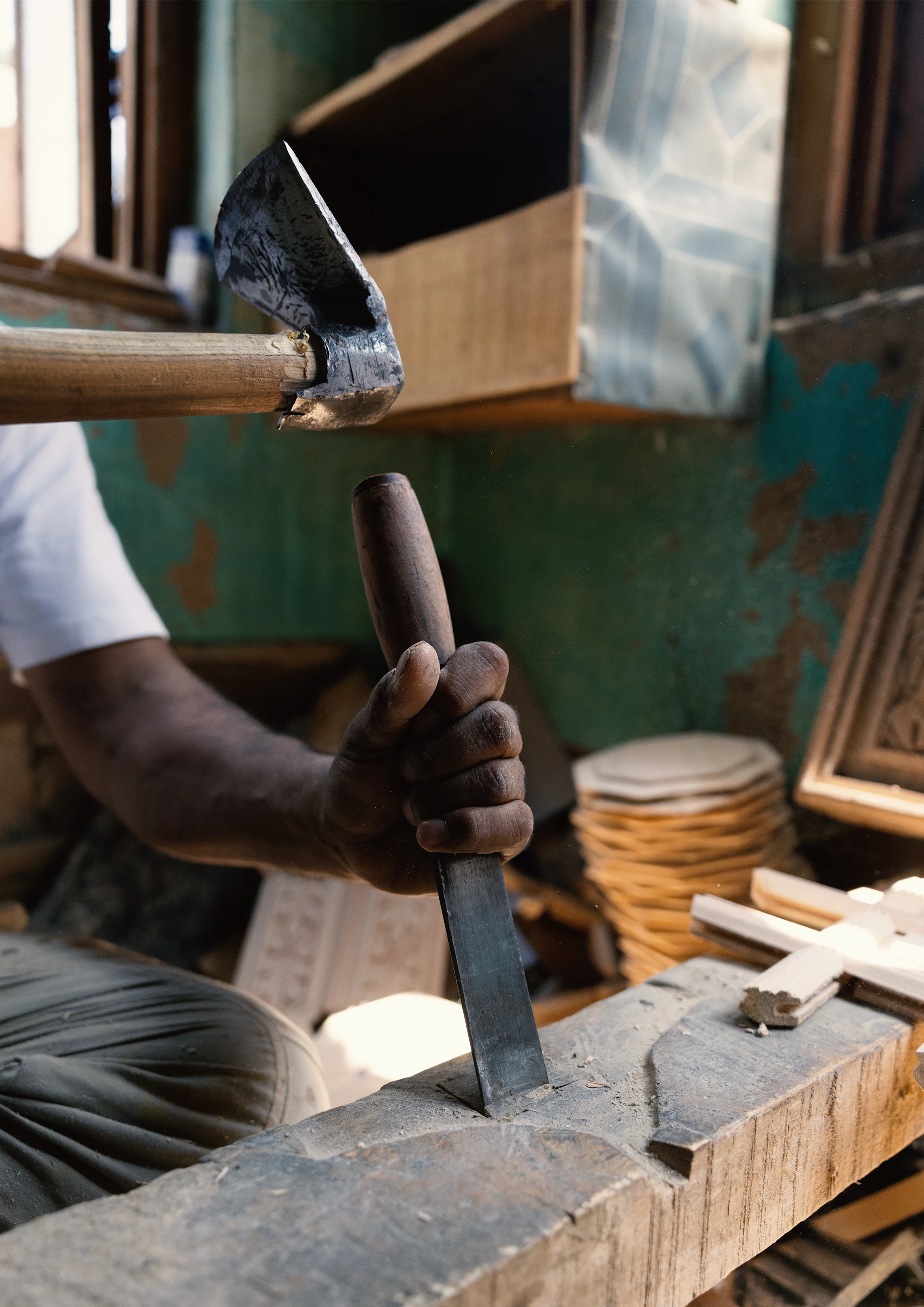 A man working on a piece of wood with a hammer
