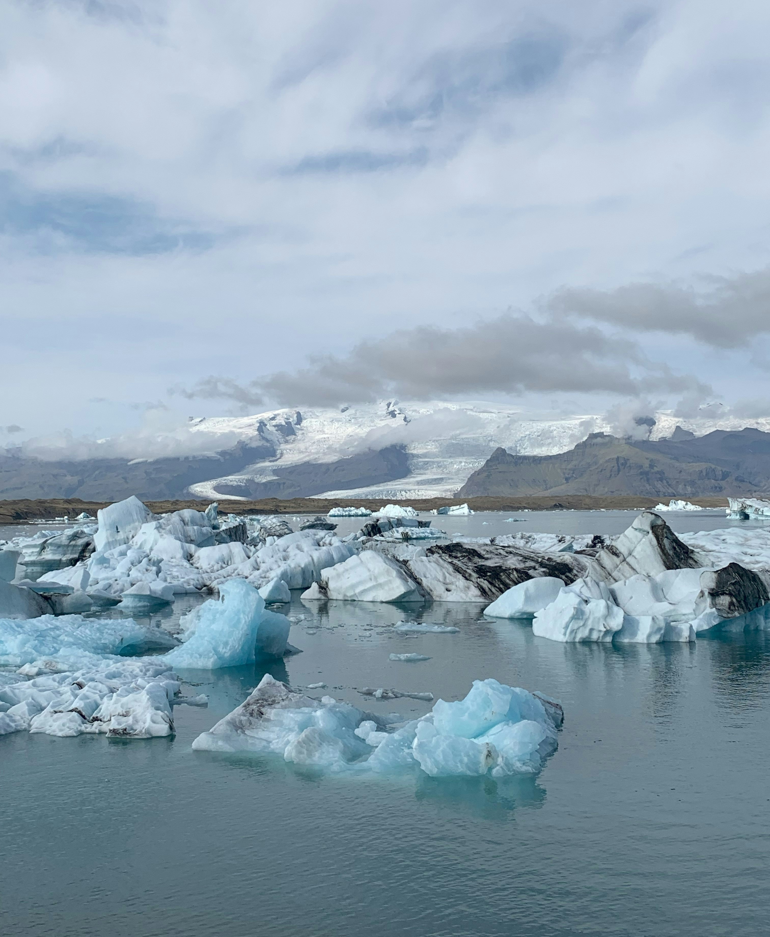 A group of icebergs floating on top of a body of water