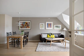 A living room filled with furniture and a dining room table