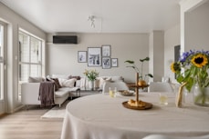A living room filled with furniture and a white table