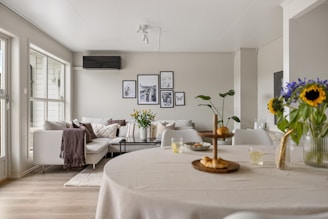 A living room filled with furniture and a white table