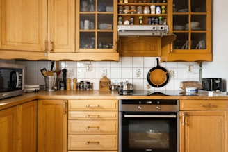 A kitchen with wooden cabinets and a stove top oven
