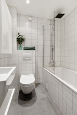 A bathroom with a toilet, sink, and bathtub