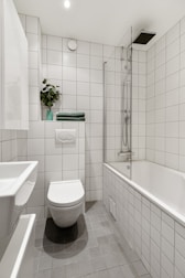 A bathroom with a toilet, sink, and bathtub