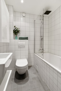 A bathroom with a toilet, sink, and bathtub