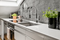 A kitchen with a skylight and a sink
