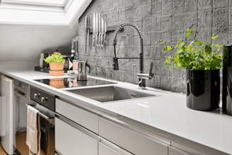 A kitchen with a skylight and a sink