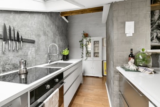 A kitchen with a sink a stove and a refrigerator