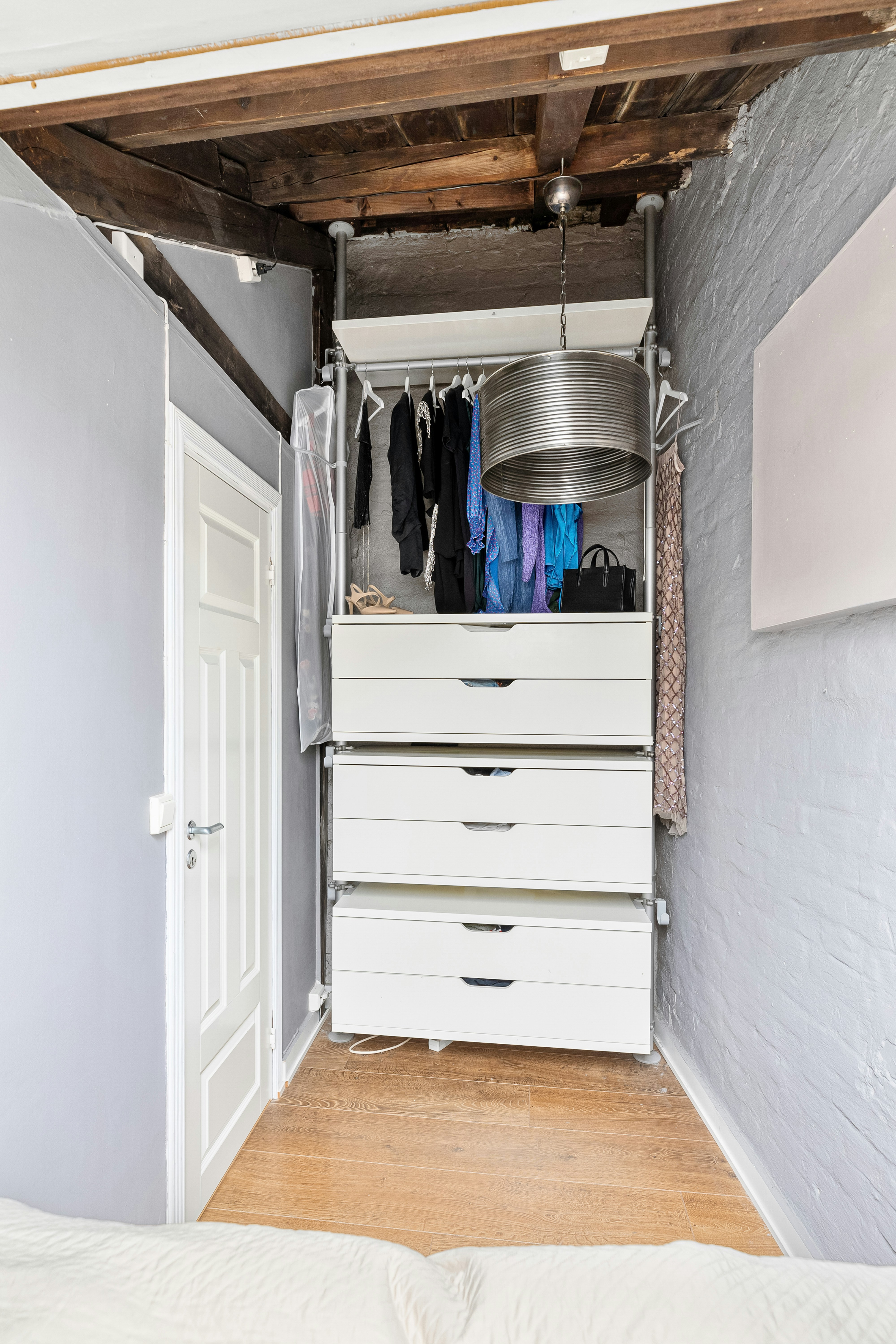 A bedroom with a bed and a closet