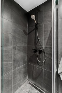 A walk in shower sitting next to a shower head