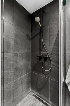 A walk in shower sitting next to a shower head