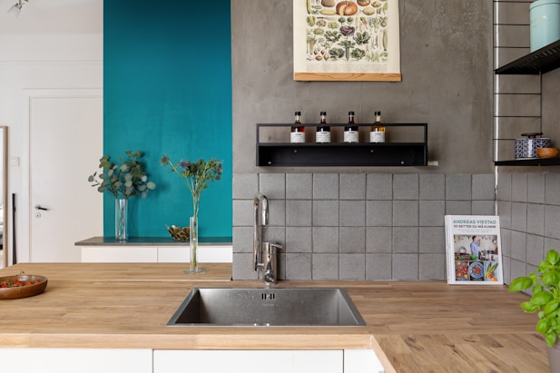 A kitchen with a wooden counter top next to a sink
