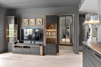 A living room with a TV and a large window