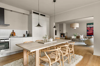A kitchen with a table and chairs and a stove