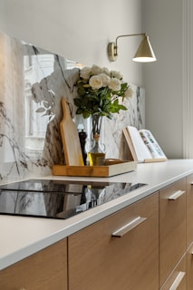 A kitchen with marble counter tops and wooden cabinets