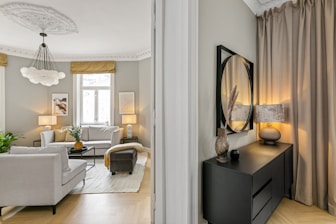 A living room filled with furniture and a mirror