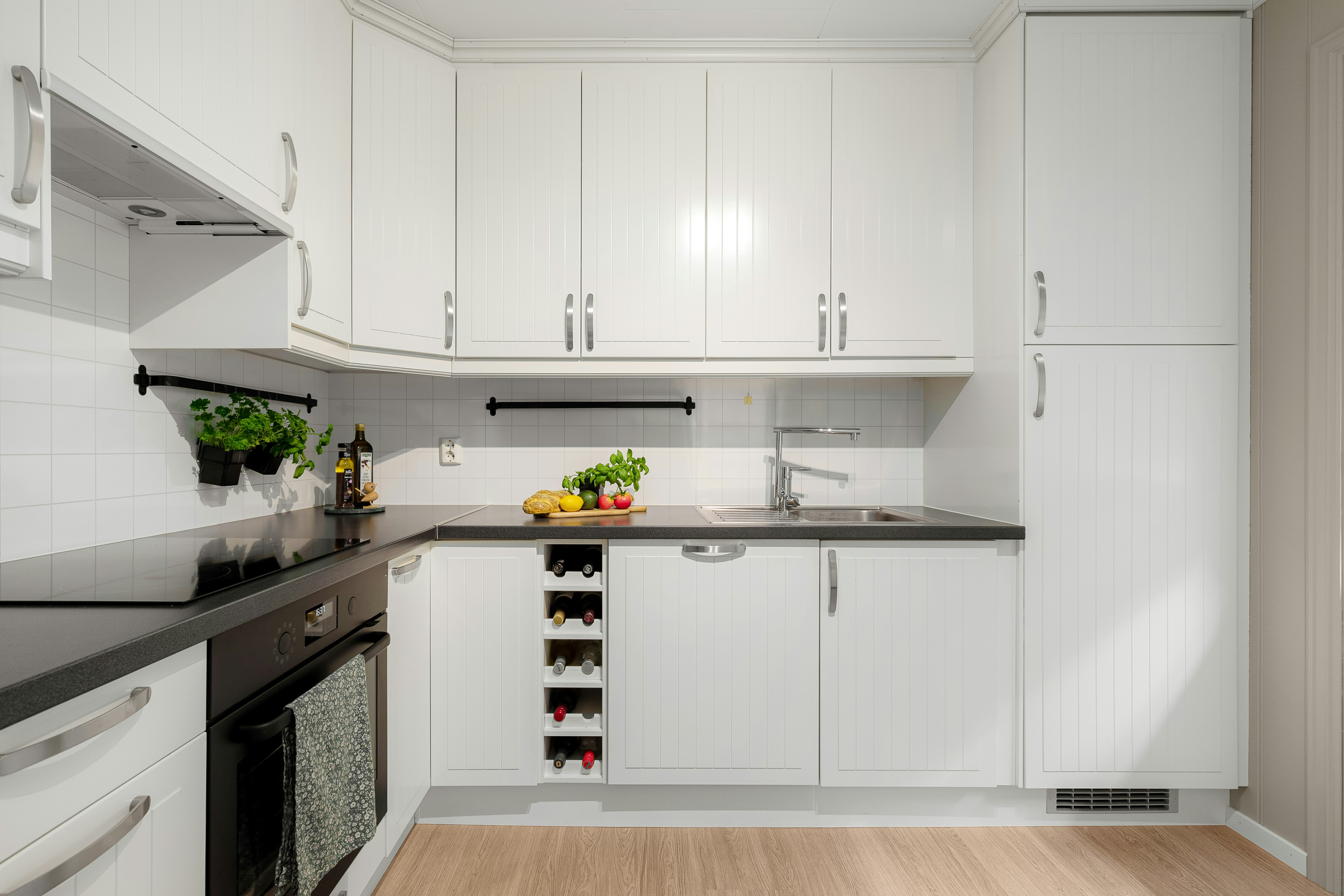 Sleek kitchen with cabinet-front appliances and Caesarstone countertops - modern studio for rent