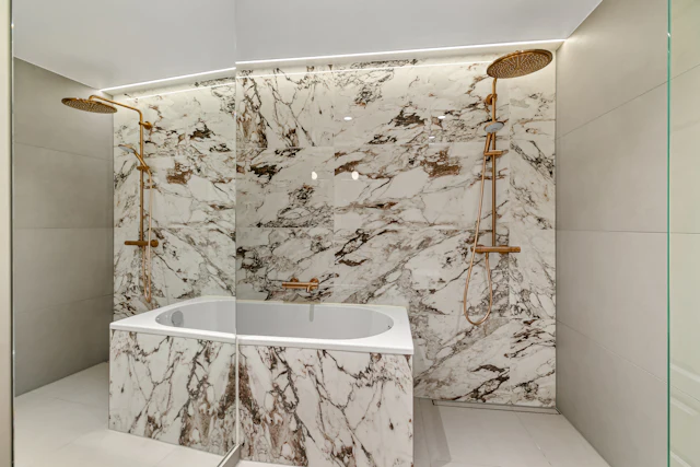 A bathroom with a marble bathtub and a walk in shower