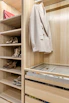A walk in closet with a lot of shoes