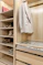 A walk in closet with a lot of shoes