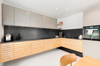 A kitchen with a table and a microwave